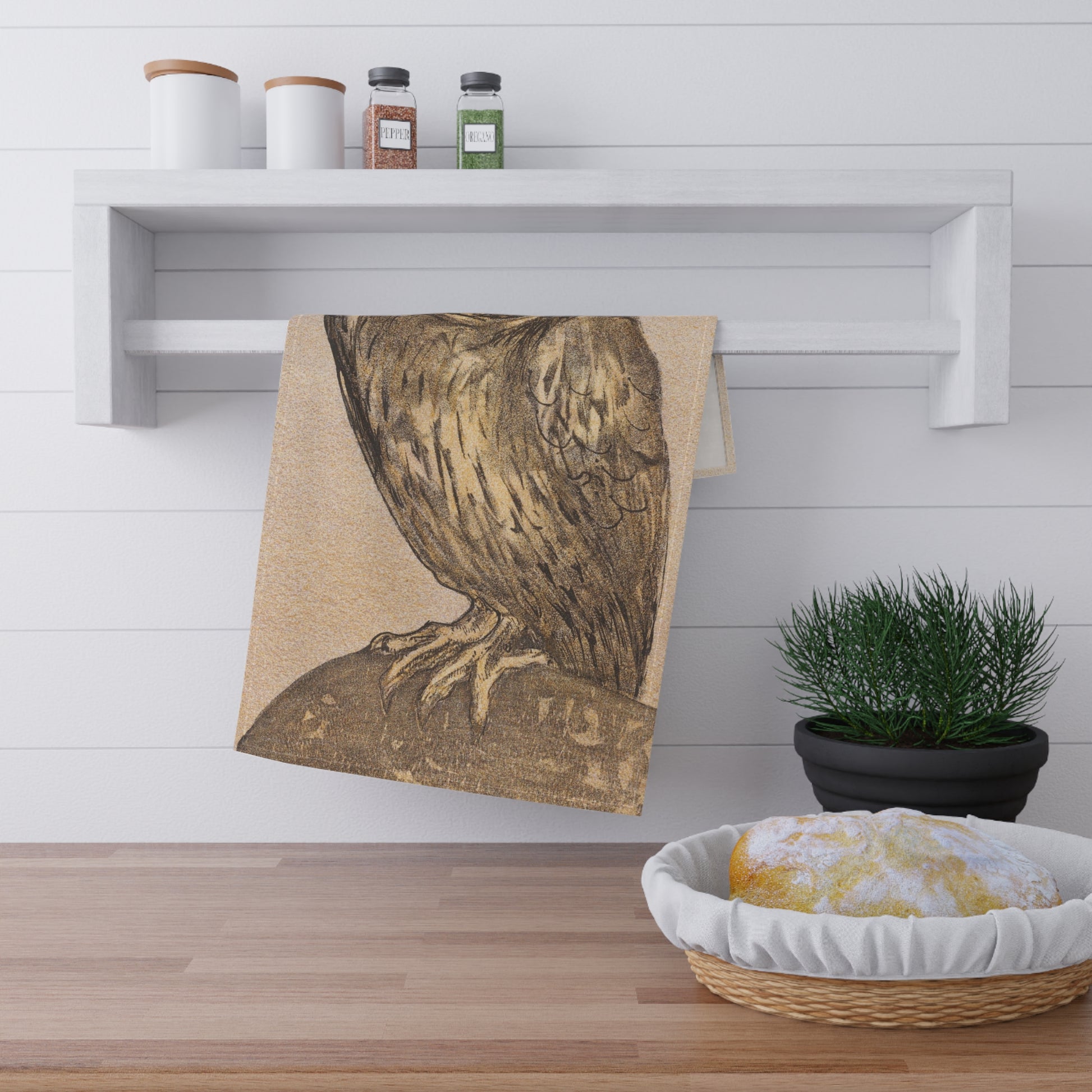 Vintage frowning owl illustration tea towel in beige and brown hanging on a kitchen rail